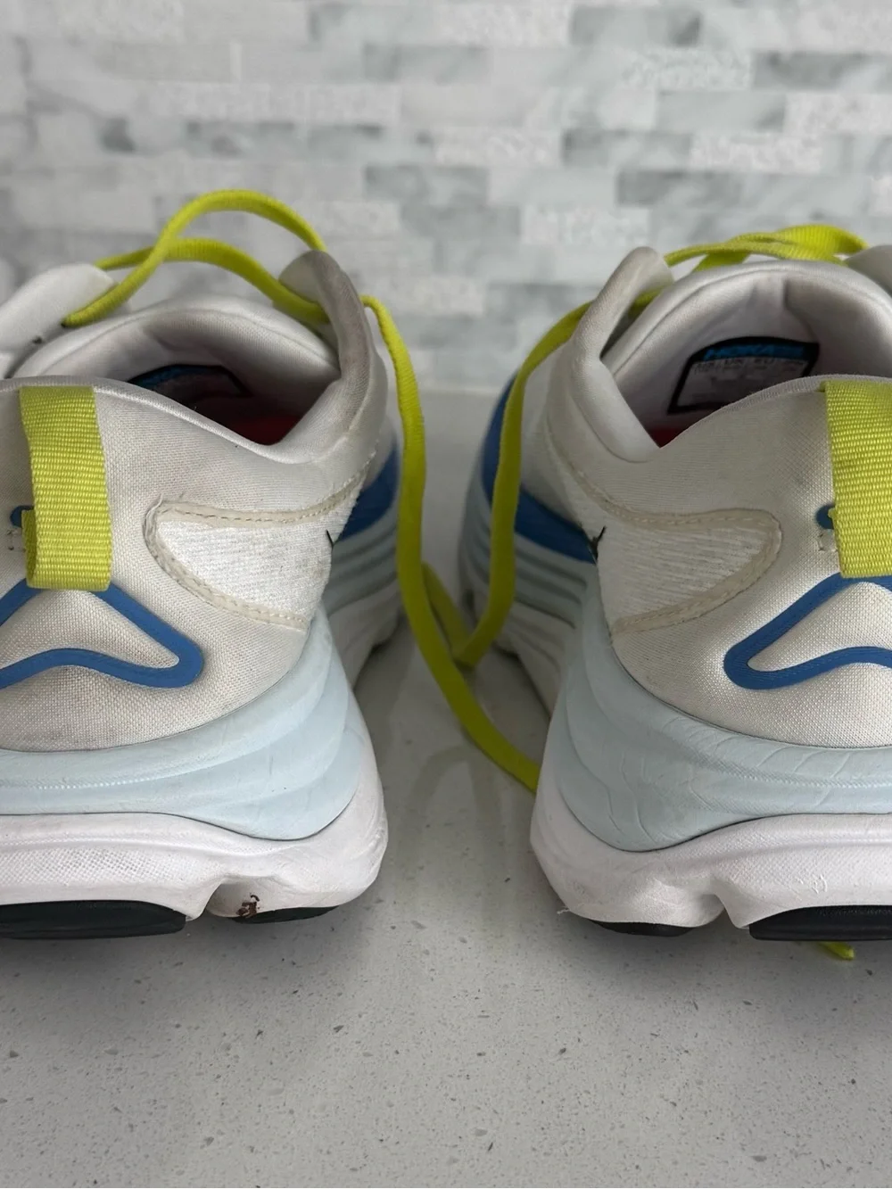 Hoka White Running Shoes with Neon Yellow Laces and Blue Accents